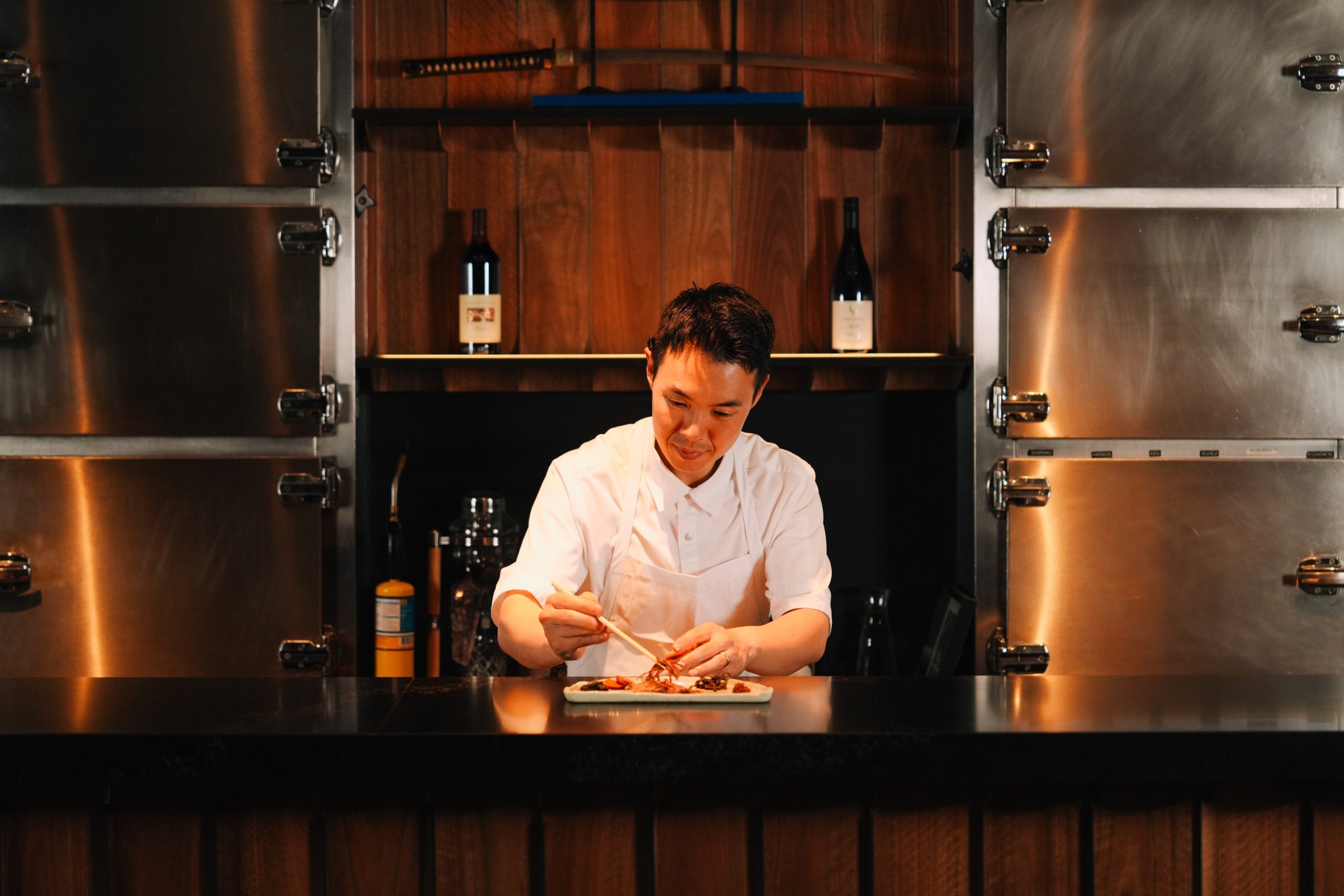 Chef preparing a dish at the counter at Ronin Omakase